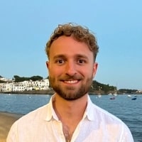 Lucas Botzen, HR Expert & CEO, Rivermate seen posing for a photo from a lake background
